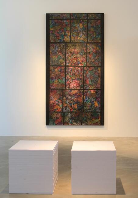 (sculpture on the ground)  Felix Gonzalez-Torres Born in Guįimaro, Cuba 1957. Died in Miami, Florida 1996  Untitled, 1989/1990 Offset print on paper, endless copies, two stacks, each stack: Ideal height: 26 x 56 x 23 inches Overall: ideal height: 26 x 56 x 23 inches  (painting on wall) Guillermo Kuitca Born in Buenos Aires, Argentina 1961. Lives and works in Buenos Aires, Argentina  Kristallnacht, 1992 Mixed Media on Canvas 118 X 61 Inches